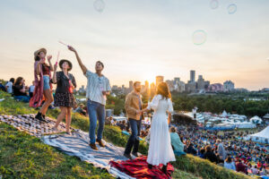 A group of friends blows bubbles on top of Gallagher Hill while waiting for the main stage performance.