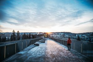 Edmonton A person walking on a bridge in the river valley at sunset