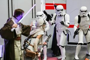 People dressed as Stormtroopers and Jedis pretend to battle at The Edmonton Comic & Entertaiment Expo.