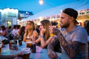 A group of friends hang out at Edmonton Fringe's beer gardens.