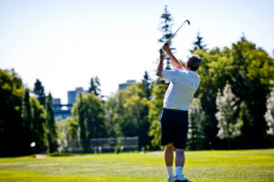 A man swings a golf club in Edmonton.