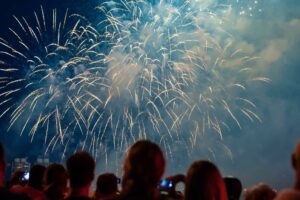 A large group of people watch a New Years Eve fireworks display