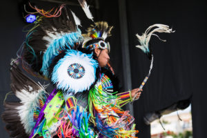 An Indigenous performer on stage.