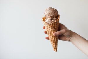 A waffle cone with peanut butter and jelly ice cream.