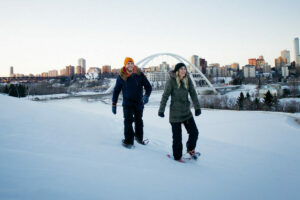A couple snowshoeing in downtown Edmonton.
