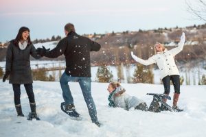 A group snowshoes in the river valley during winter.