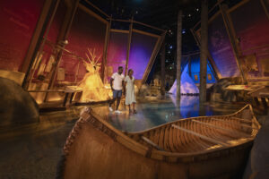 A couple walks through the Indigenous Peoples Experience exhibit at Fort Edmonton Park