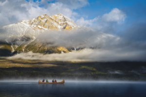 Canoe on a lake with a mountain in the background