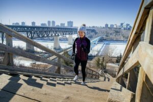 A women runs up an outdoor staircase in winter.