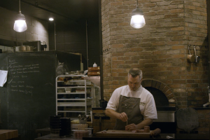 Blair Lesback preparing food in the kitchen at Edmonton restaurant Range Road.