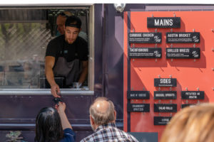 People lined up for food truck.