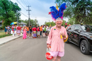 A man in a feather headpiece celebrates Pride in Edmonton.