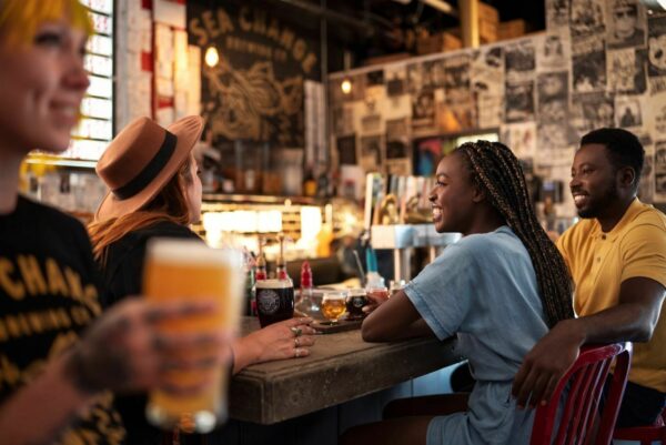 A couple sits at the bar of a local brewery in Edmonton.