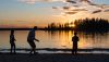 A family throws rocks at Astotin Lake.