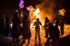 People gather around a fire sculpture at Silver Skate Festival.