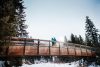 Couple stand on a bridge in Edmonton's river valley in the winter