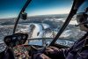 Pilot flying above city on an Edmonton regional helicopter tour