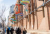 people walk past the neon sign museum in edmonton