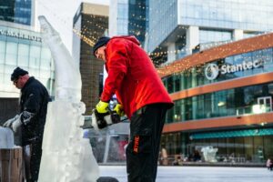 A man carves an ice sculpture.