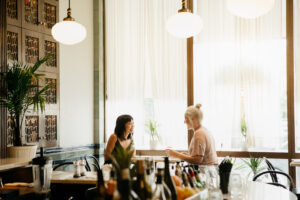 Two women sit inside Clementine