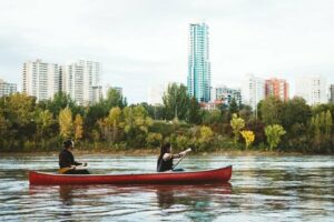 A young couple canoes down the river.