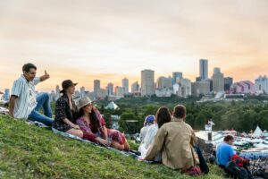 A group of five sit on the hill.