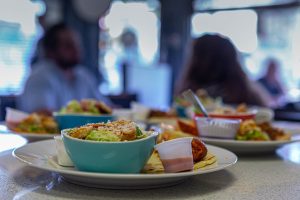 A salad on a plate with tacos.