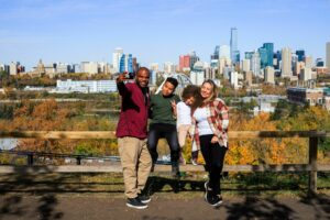 A family poses in front of the Edmonton skyline in fall