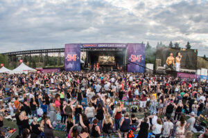 A crowd gathers in front of the stage.