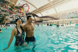 Couple stands in the water of the pool at West Edmonton Mall's World Waterpark.