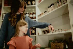 A mother and daughter look at items in Whiskeyjack Art House.