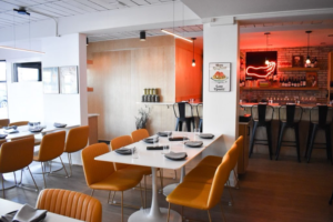 Interior view of tables dining tables and bar at bella restaurant