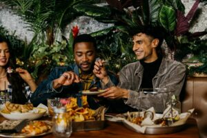 Three people eat at a table at Banquet