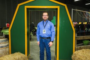 A man poses inside a barn door at Farmair International.
