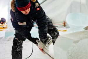 A sculptor chisels an ice carving at Edmonton's Ice on Whyte Festival.